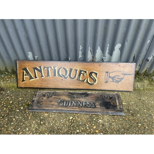 22 - A hand painted antiques sign on oak board 87x26 together with wooden Guinness sign