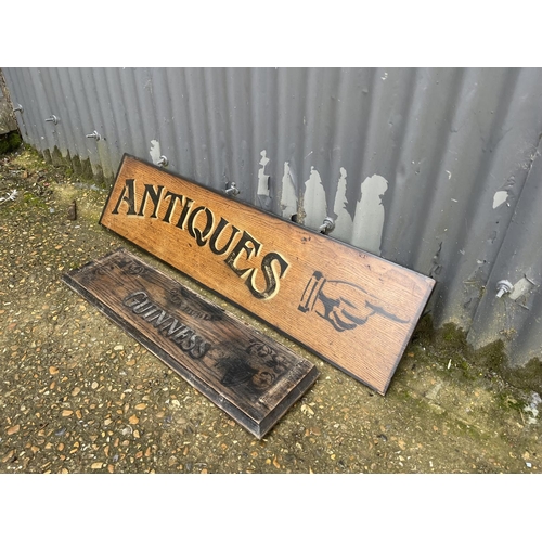 22 - A hand painted antiques sign on oak board 87x26 together with wooden Guinness sign