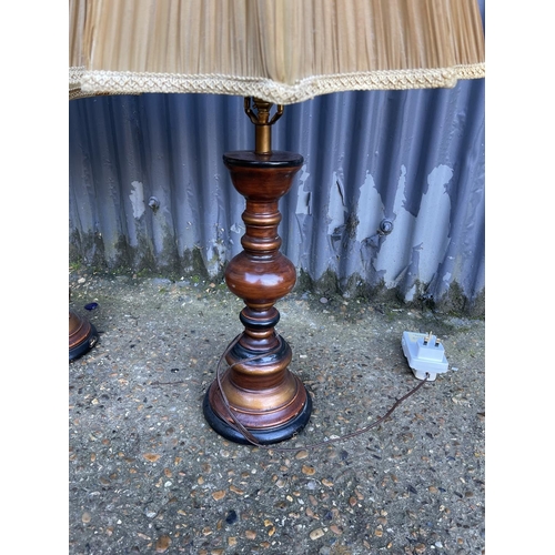 224 - A pair of wooden table lamps with shades 80cm high