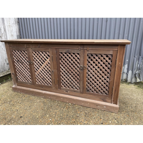 234 - A pine sideboard with four lattice doors 175x45x88