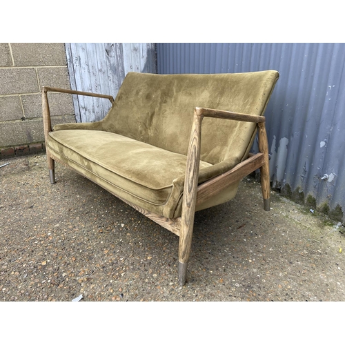 237 - A modern green upholstered two seater love seat 150cm wide