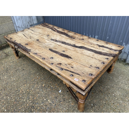 238 - A large driftwood coffee table with iron stud decoration 180x97x50