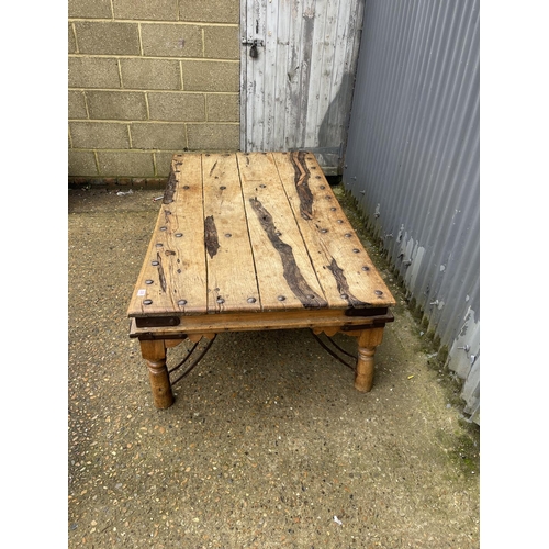 238 - A large driftwood coffee table with iron stud decoration 180x97x50