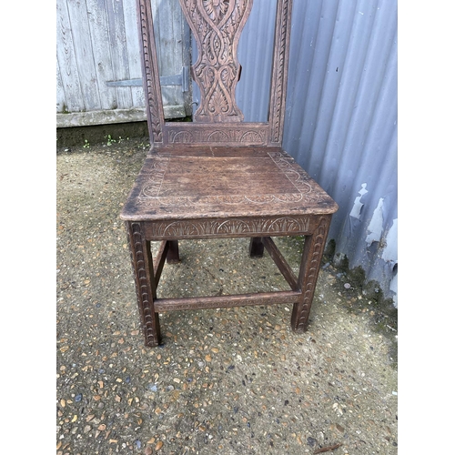 243 - An antique carved oak chair