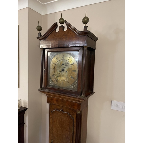 263 - An oak caxed longcase clock with brass dial