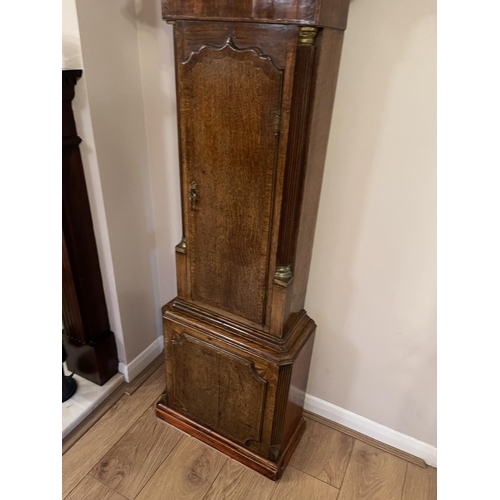 263 - An oak caxed longcase clock with brass dial