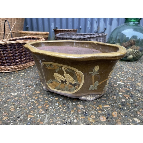 3 - 8 pieces of basket-ware, a glass carboy and a ceramic planter