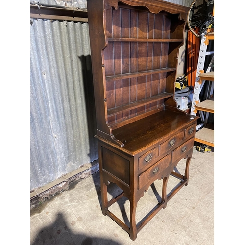 323 - A good quality reproduction oak dresser by Titchmarsh & Godwin or similar, removable plate rack top ... 