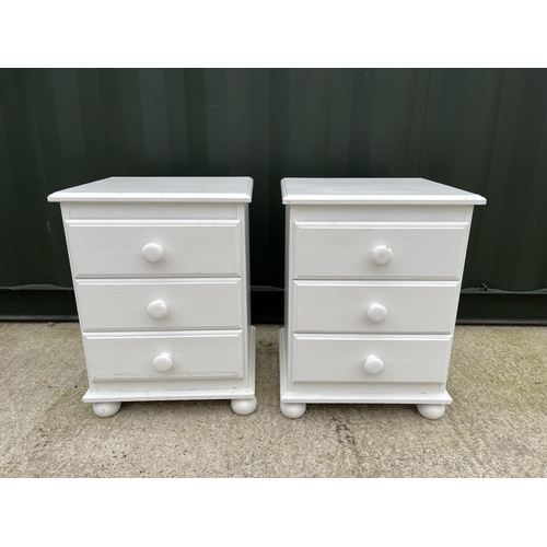 333 - A pair of white painted pine bedside chests of three