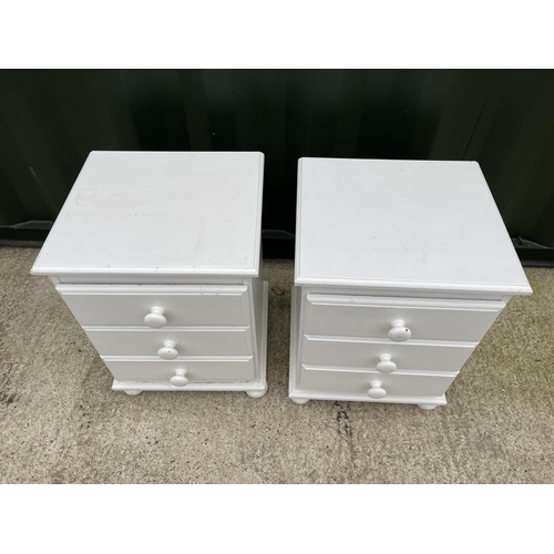 333 - A pair of white painted pine bedside chests of three