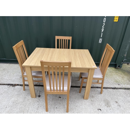 340 - A modern beechwood effect extending dining table together with 4 matching chairs by Caxton furniture... 