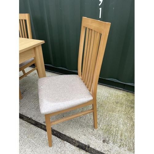 340 - A modern beechwood effect extending dining table together with 4 matching chairs by Caxton furniture... 