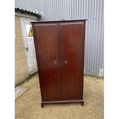 35 - A stag minstrel double wardrobe fitted to the interior