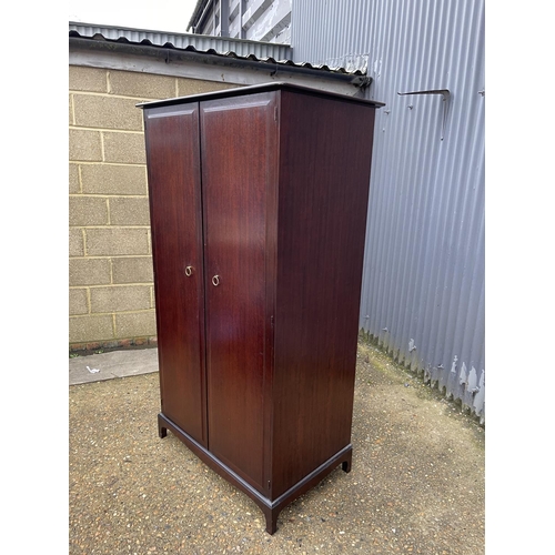 35 - A stag minstrel double wardrobe fitted to the interior