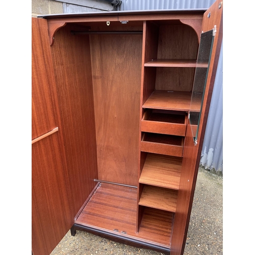 35 - A stag minstrel double wardrobe fitted to the interior