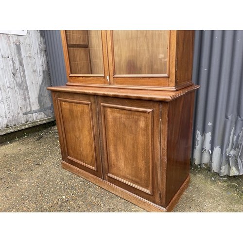 38 - A large Edwardian mahogany glazed bookcase cupboard with four glass adjustable shelves   120x50x 233