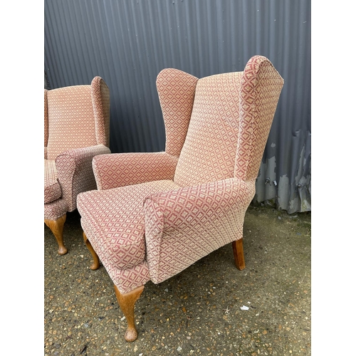 40 - A pair of red and gold upholstered wing back armchairs