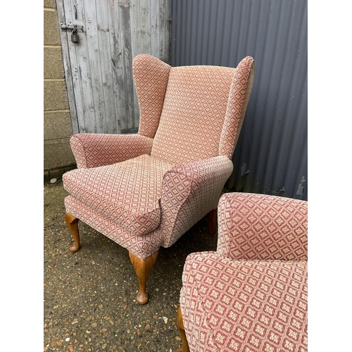 40 - A pair of red and gold upholstered wing back armchairs