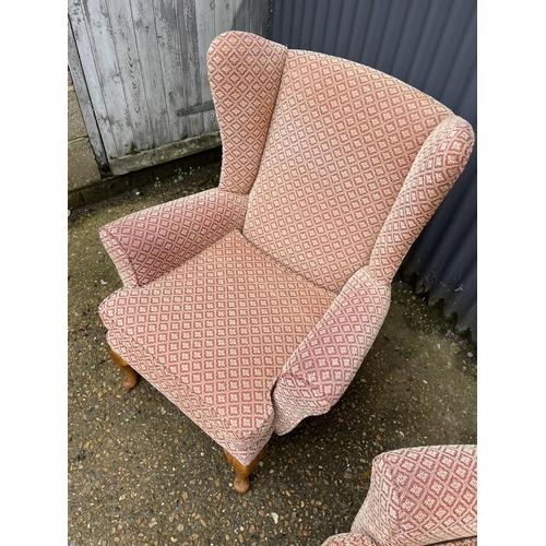 40 - A pair of red and gold upholstered wing back armchairs