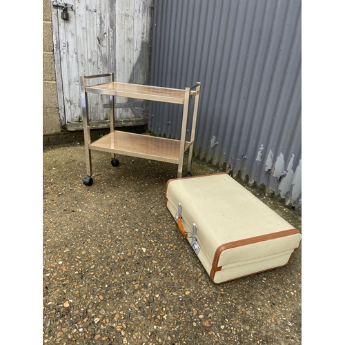 46 - A retro two tier tea trolley, together with a revelation suit case