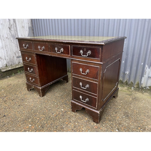 48 - A reproduction mahogany twin pedestal desk with green leather top