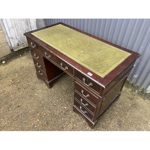 48 - A reproduction mahogany twin pedestal desk with green leather top