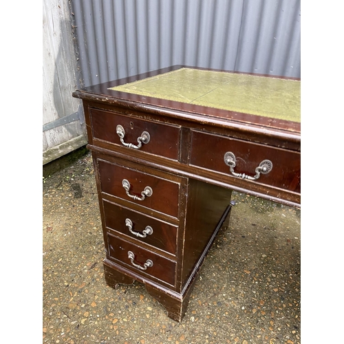 48 - A reproduction mahogany twin pedestal desk with green leather top