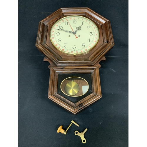 534 - Octagonal wall clock by Ethan Allen, height 66cms with pendulum and two keys