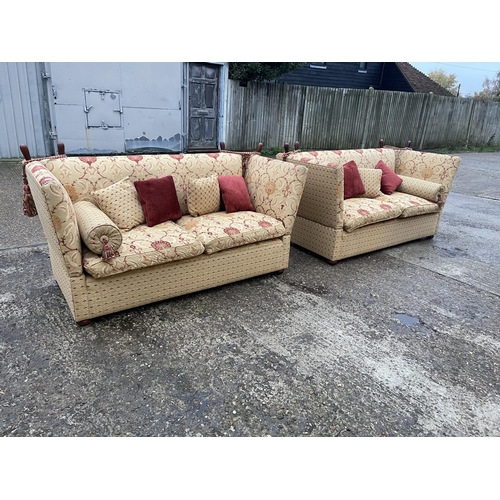 54 - A pair of grand red and gold pattern drop end Knoll sofas with associated bolster and scatter cushio... 