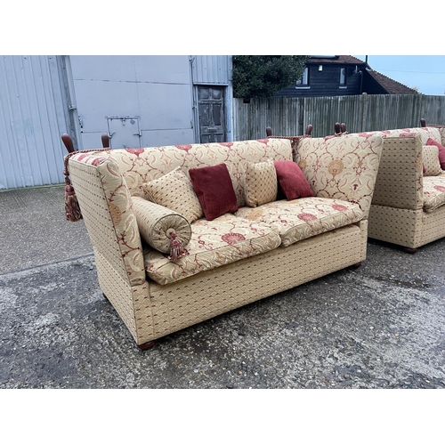 54 - A pair of grand red and gold pattern drop end Knoll sofas with associated bolster and scatter cushio... 