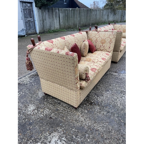 54 - A pair of grand red and gold pattern drop end Knoll sofas with associated bolster and scatter cushio... 