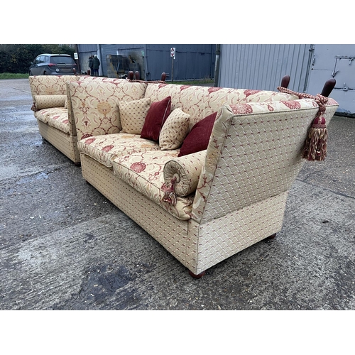 54 - A pair of grand red and gold pattern drop end Knoll sofas with associated bolster and scatter cushio... 