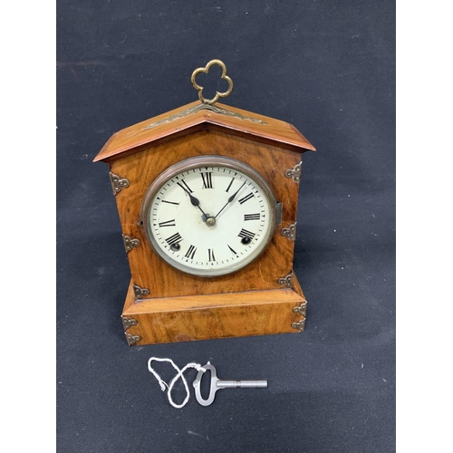 587 - Victorian Walnut cased mantel clock, with brass mounts and key, height 28cms