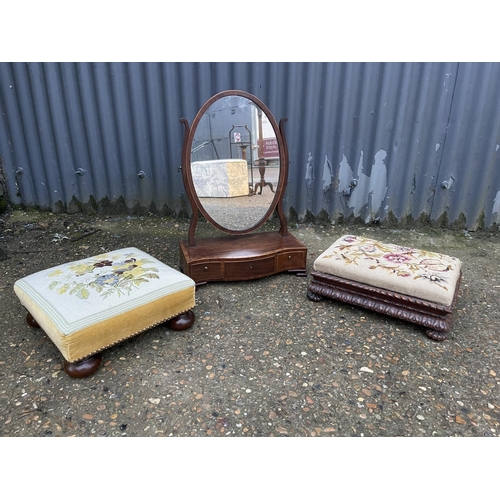 59 - A victorian swing mirror together with two tapestry footstools