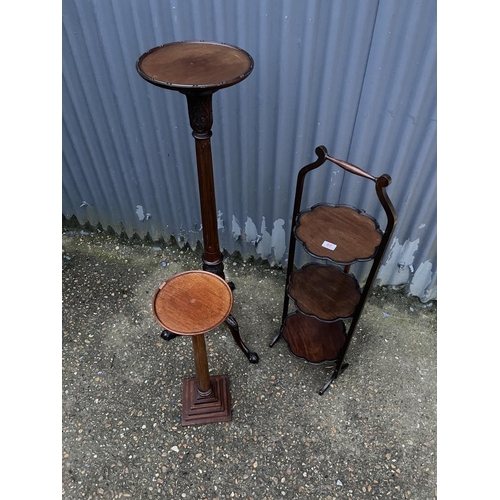 60 - A mahogany torchere stand, a wine table and an ornate folding cake stand