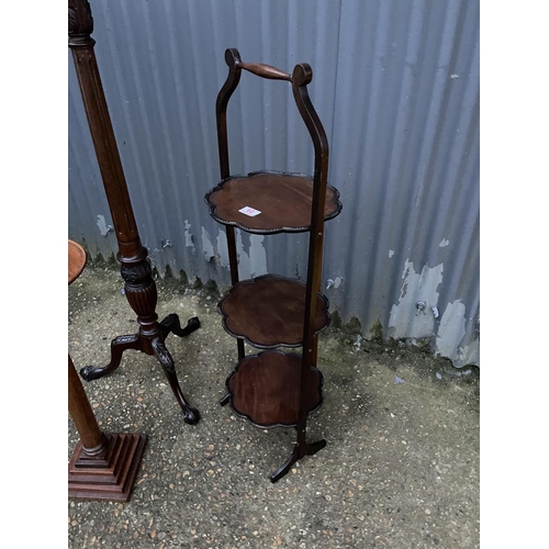 60 - A mahogany torchere stand, a wine table and an ornate folding cake stand