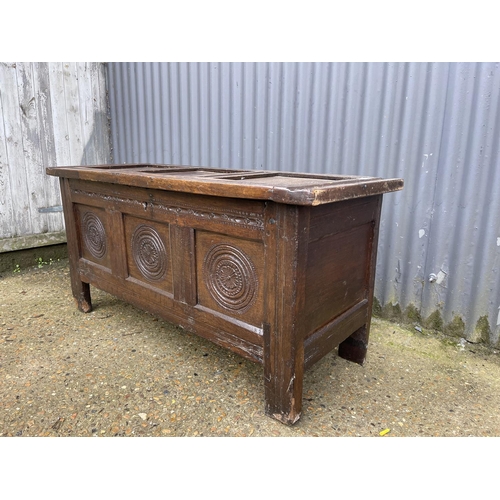 68 - A carved oak three panel coffer