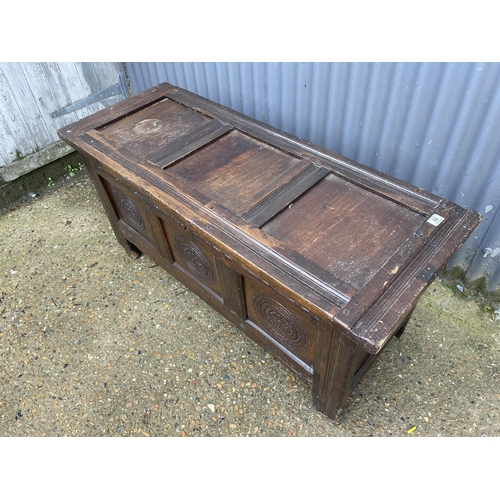 68 - A carved oak three panel coffer