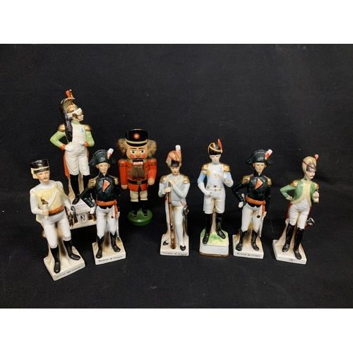 787 - Seven porcelain soldier figures and wooden nutcracker