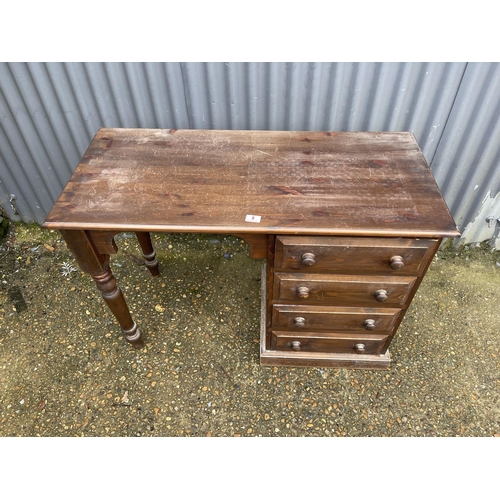 8 - A solid pine four drawer desk 107x 47x76