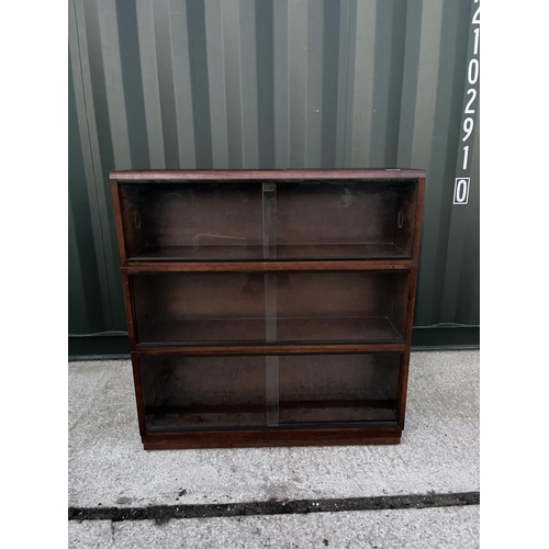 299 - An early 20th century three section oak stacking bookcase labelled simplex 91cm wide