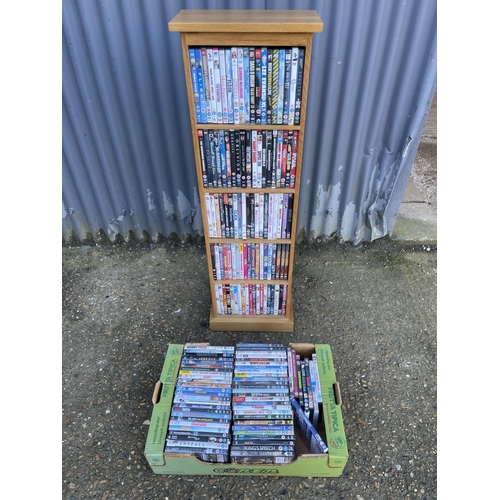 108 - An oak dvd rack filled  with dvds together with a tray of dvd