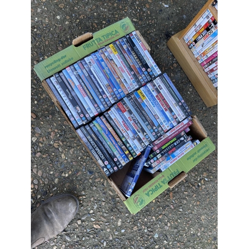 108 - An oak dvd rack filled  with dvds together with a tray of dvd