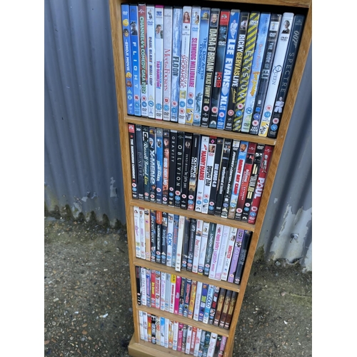 108 - An oak dvd rack filled  with dvds together with a tray of dvd