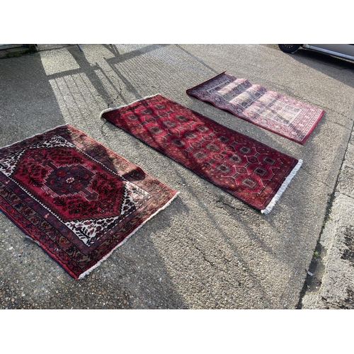 11 - Three red pattern oriental rugs largest 107x 210