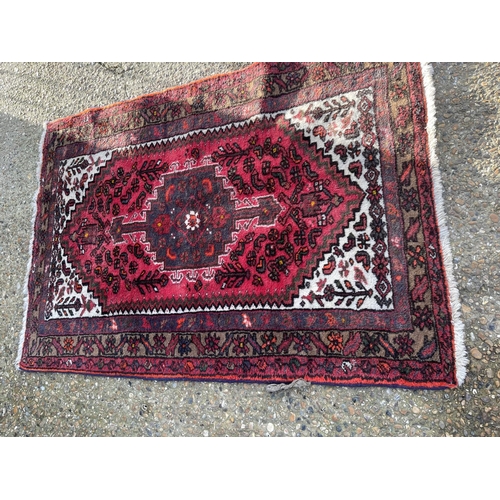 11 - Three red pattern oriental rugs largest 107x 210