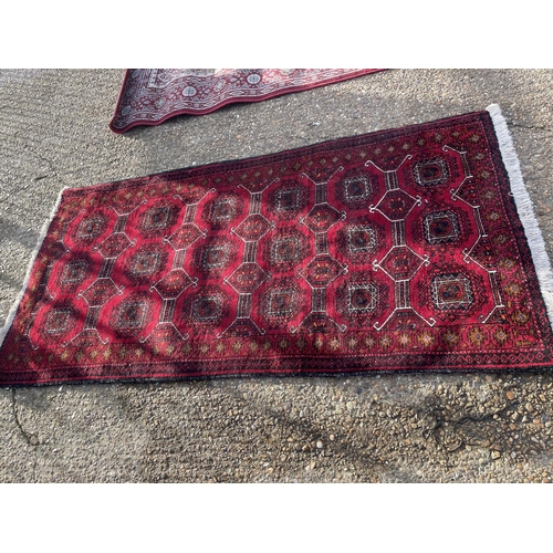 11 - Three red pattern oriental rugs largest 107x 210