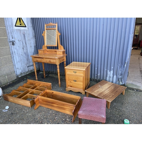 110 - A pine dressing table together with  three pine racks and a bedside