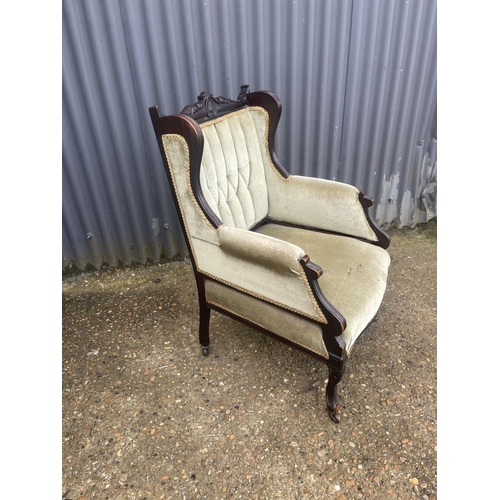 154 - An Edwardian green upholstered salon chair