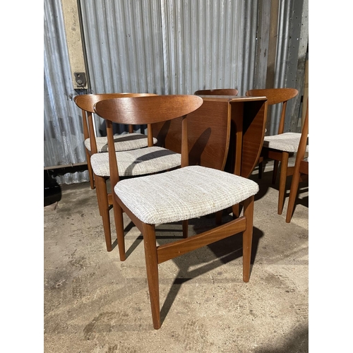 196 - A mid century teak gate-leg dining table together with a set of six matching teak chairs